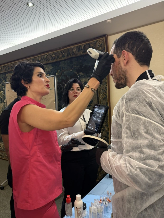 Healthcare professional performing facial vascular mapping with ultrasound