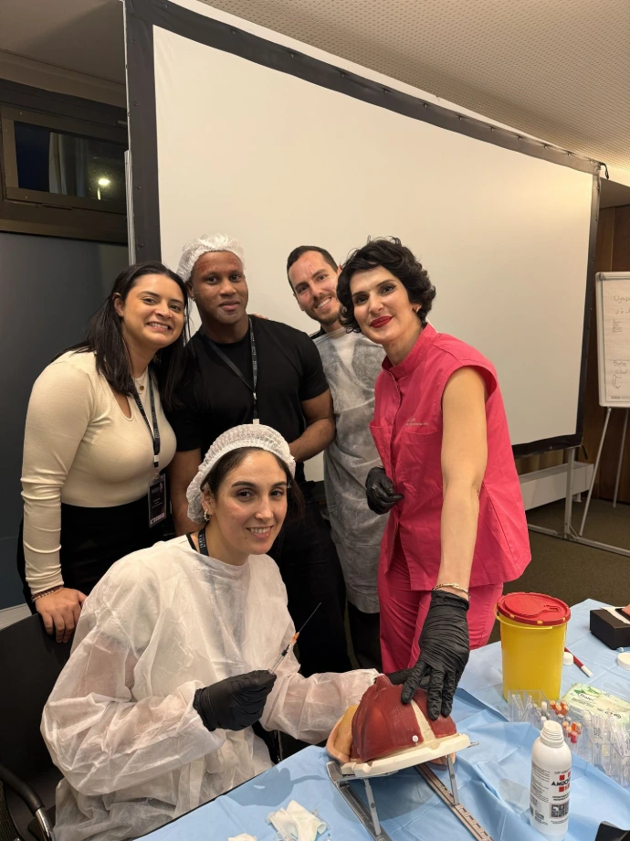 Doctors participating in hands-on aesthetic medicine training with facial simulators